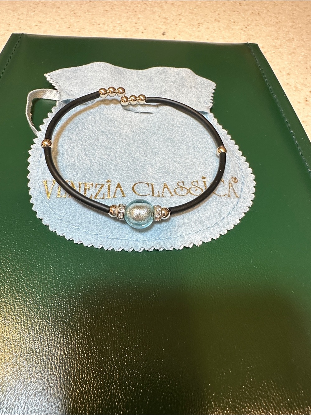 Black Bracelet with Light Blue Glass Accent